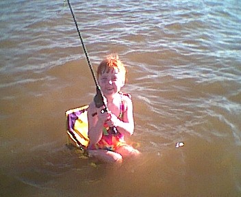 1995 Ford Crown Victoria - A child enjoys a day of fishing while sitting in the water.