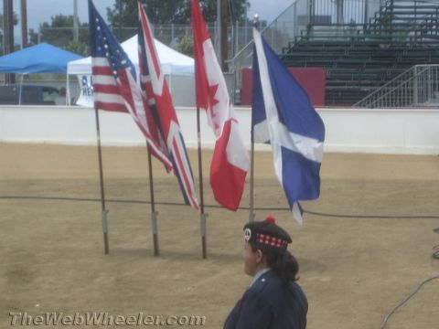 1968 Ford Mustang - Event photo of US, UK, Canadian and Scottish flags on poles, not a technical document.