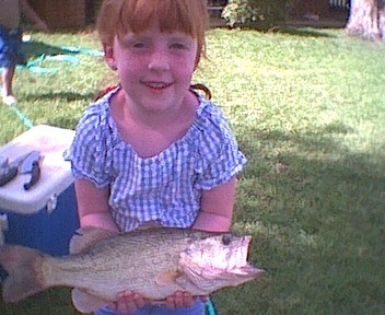 1995 Ford Crown Victoria - A young girl smiles while holding a freshly caught fish.