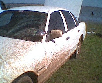 1995 Ford Crown Victoria - A white 1995 Ford Crown Victoria is shown from the front three-quarter view with its hood open.