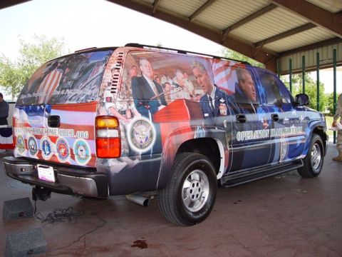 1995 Ford Crown Victoria - This SUV is decorated with patriotic imagery and text related to military operations.
