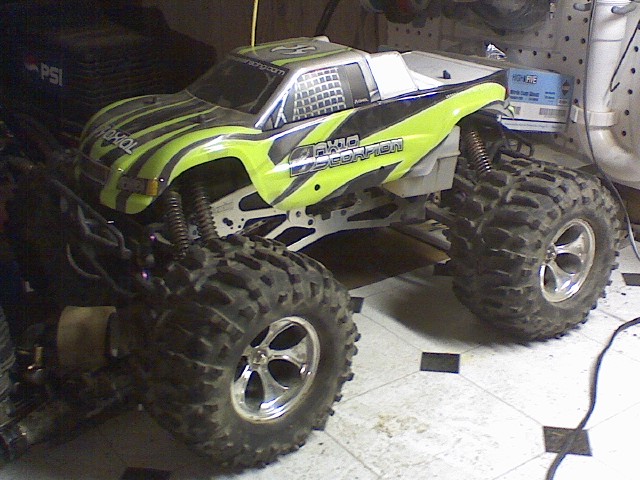 Remote-controlled monster truck with green and black graphics.