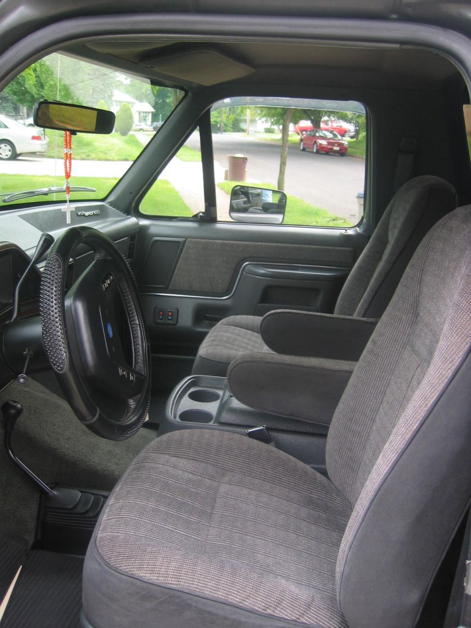 Interior of a Ford Bronco showing seats, steering wheel, and dashboard.