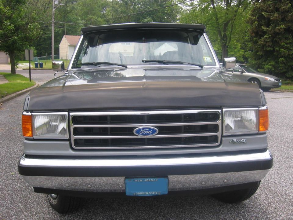 1990 Ford Bronco front view, gray with black hood and chrome grille