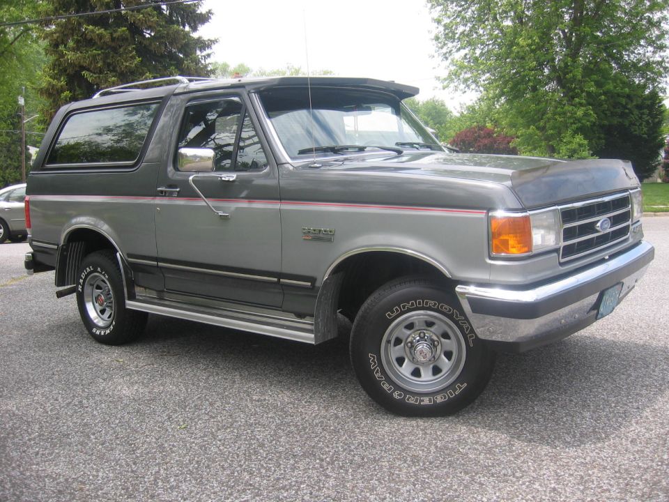 1990 Ford Bronco in two-tone gray, parked outdoors.