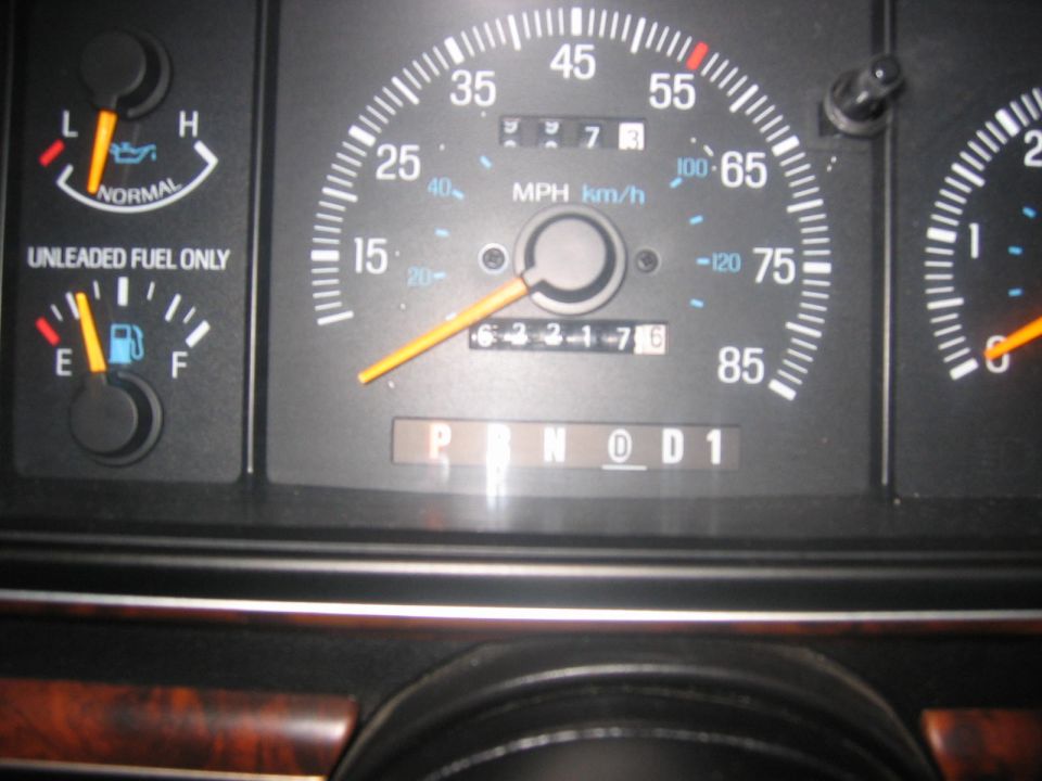 Dashboard of a 1990 Ford Bronco showing speedometer, fuel gauge, and gear indicator.