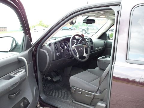 1996 Ford Bronco - The interior of a dark-colored pickup truck is shown from the driver's side door, looking towards the dashboard and front passenger seat. T…