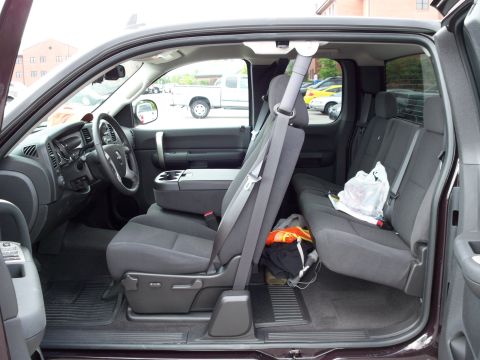 1996 Ford Bronco - The interior of a dark colored pickup truck is shown, featuring the front driver's seat, dashboard, steering wheel, and the rear bench seat…