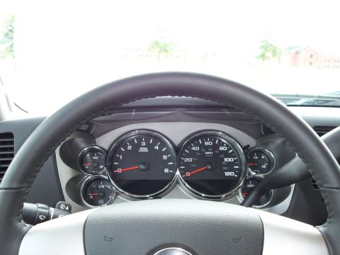 1996 Ford Bronco - The interior of a vehicle shows a close-up of the steering wheel and dashboard gauges, including the speedometer and tachometer.