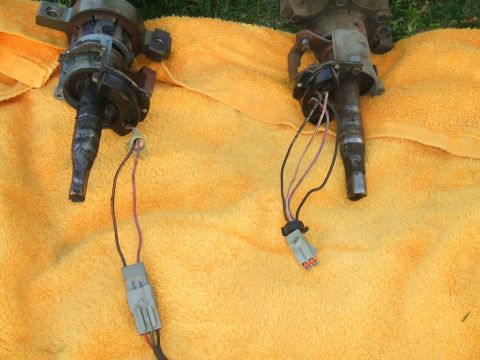 1974 Ford Ranchero - Two steering column ignition lock cylinder assemblies with wiring harnesses are laid out on a bright orange towel. The assemblies appear to…