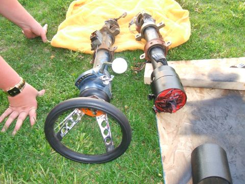 1974 Ford Ranchero - Two disassembled steering columns with steering wheels are laid out on a grassy lawn next to a yellow towel and some wooden planks. One ste…