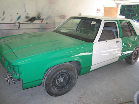 1991 Ford LTD Crown Victoria - Photo of a partially painted sedan in a shop, not a technical document.