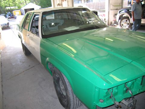 1991 Ford LTD Crown Victoria - Photo of a two-tone sedan undergoing bodywork, not a technical document.