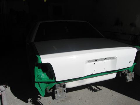 1991 Ford LTD Crown Victoria - Photo of a sedan rear end on stands during bodywork, not a technical document.