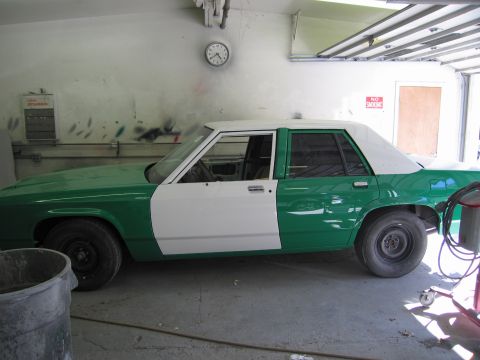 1991 Ford LTD Crown Victoria - Photo of a two-tone sedan in a garage, not a technical document.
