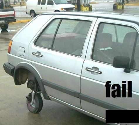 2000 Mercury Grand Marquis - This vehicle has experienced a significant mechanical failure, with its rear wheel detached.