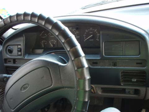 1995 Ford F-150 - Interior view of a 1995 Ford F-150 dashboard, showing the steering wheel, instrument cluster, and air vents.