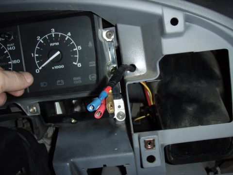 1995 Ford F-150 - Dashboard wiring and gauges are visible, with a hand interacting with the tachometer.