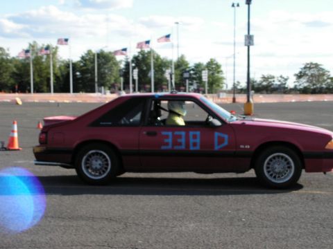 1990 Ford Mustang - Side view of a red 1990 Ford Mustang coupe participating in an autocross event.