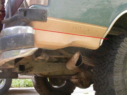1990 Ford Bronco - Close-up view of the rear tire and bumper assembly of an older model vehicle.