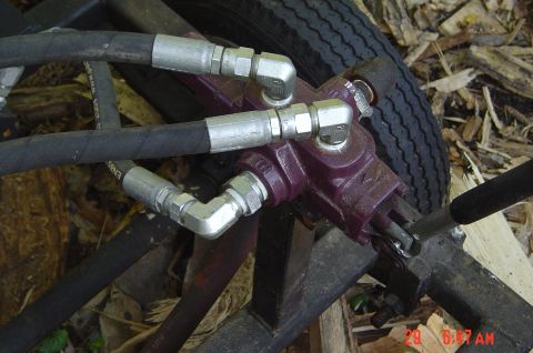 1946 Ford F1 - Hydraulic valve assembly with hoses and a tire in the background.