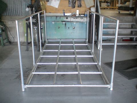 1993 Ford C-350 (Centurion Conversions) - Metal platform with railings and grid floor, viewed from front in a workshop setting.