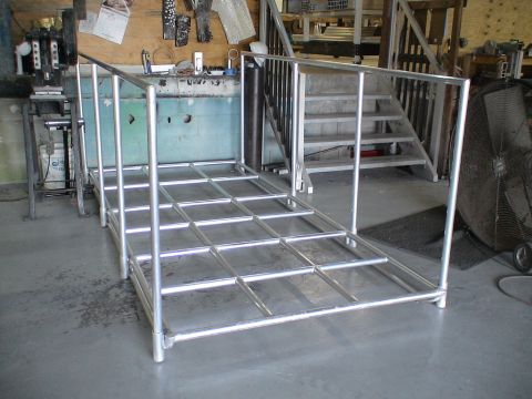 1993 Ford C-350 (Centurion Conversions) - A metal viewing platform with a grid-like surface and handrails is shown in a workshop setting.