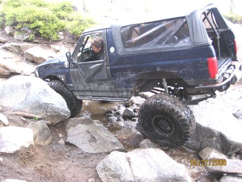 1994 Ford Bronco - Ford Bronco tackles a challenging rocky trail, demonstrating its off-road capabilities.