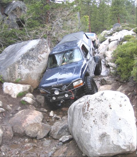 1994 Ford Bronco - This 1994 Ford Bronco is tackling a challenging off-road course with large rocks and inclines.
