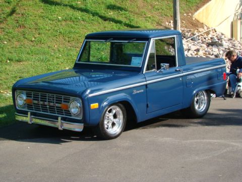 1994 Ford Bronco - This blue Ford Bronco pickup truck features a classic body style and custom wheels.