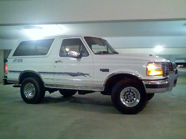 White 1996 Ford Bronco parked in a garage