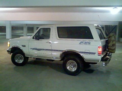 1996 Ford Bronco - This white Ford Bronco is parked in a garage, showing its side profile with FX4 Off-Road decals.