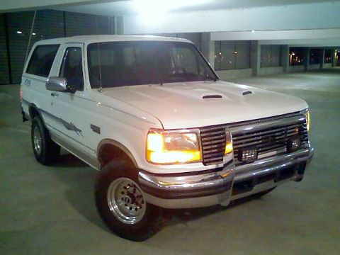 1996 Ford Bronco - A white Ford Bronco is shown from a three-quarter front angle in a parking garage.