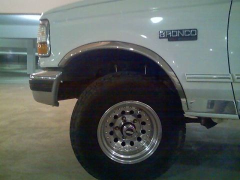1996 Ford Bronco - The "BRONCO" badge on the fender confirms this is a 1996 Ford Bronco, seen from the front three-quarter view.