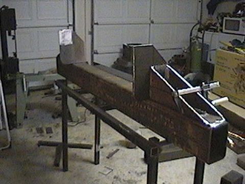 1992 Ford Bronco - Workshop scene with a metal fabrication project on a stand, next to a band saw.
