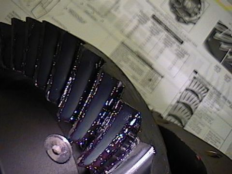 1992 Ford Bronco - Differential gears are shown coated in lubricant, with technical diagrams visible behind the part.