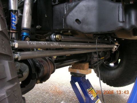 1996 Ford Bronco - Custom steering linkage and suspension components are visible on a vehicle supported by a jack.