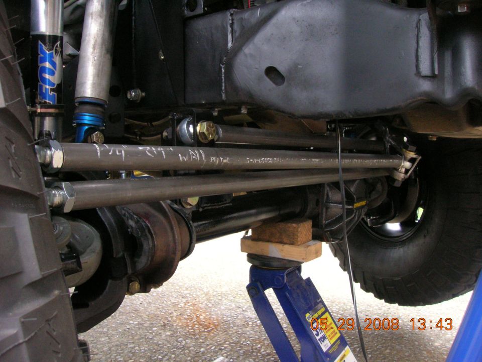 modified steering linkage with fox shocks and a jack under the axle