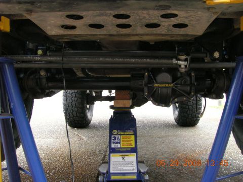 1996 Ford Bronco - Vehicle undercarriage with a Dynatrac differential, supported by jack stands.