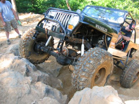 1992 Ford Mustang - A modified Jeep Wrangler navigates a challenging off-road course.