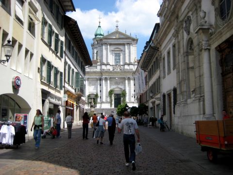 1996 Ford Bronco - Street scene in a European city with a prominent church at the end of the road.