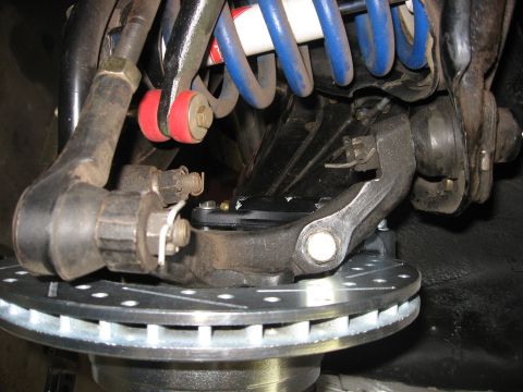 1978 Ford Mustang II - This image shows a close-up view of a vehicle's front suspension system, including brake components and shock absorber.