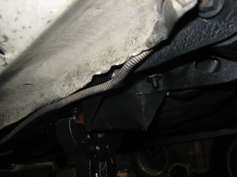 1978 Ford Mustang II - Close-up view of a vehicle's undercarriage, showing structural components and wiring.