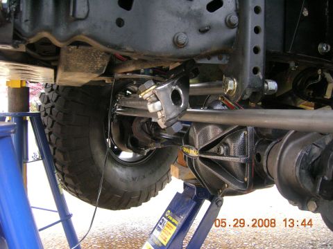 1996 Ford Bronco - Close-up of off-road vehicle suspension components, including a differential and tire, supported by jack stands.