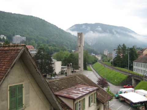 1996 Ford Bronco - A view of a town in a valley, with a prominent concrete tower and lush green mountains in the background.