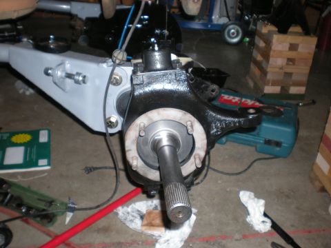 1993 Ford Bronco - Close-up view of a vehicle's front axle assembly, a splined shaft and heavy-duty components.