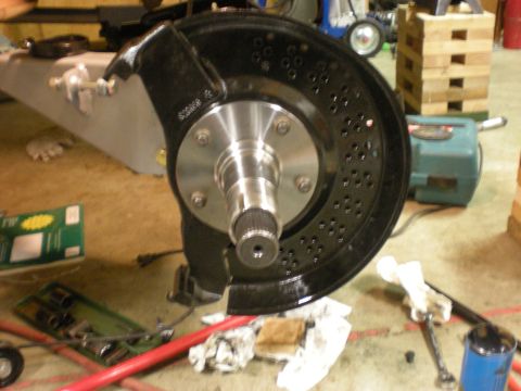 1993 Ford Bronco - A close-up view of a drilled brake rotor and hub assembly, a splined axle, likely for an off-road vehicle modification.
