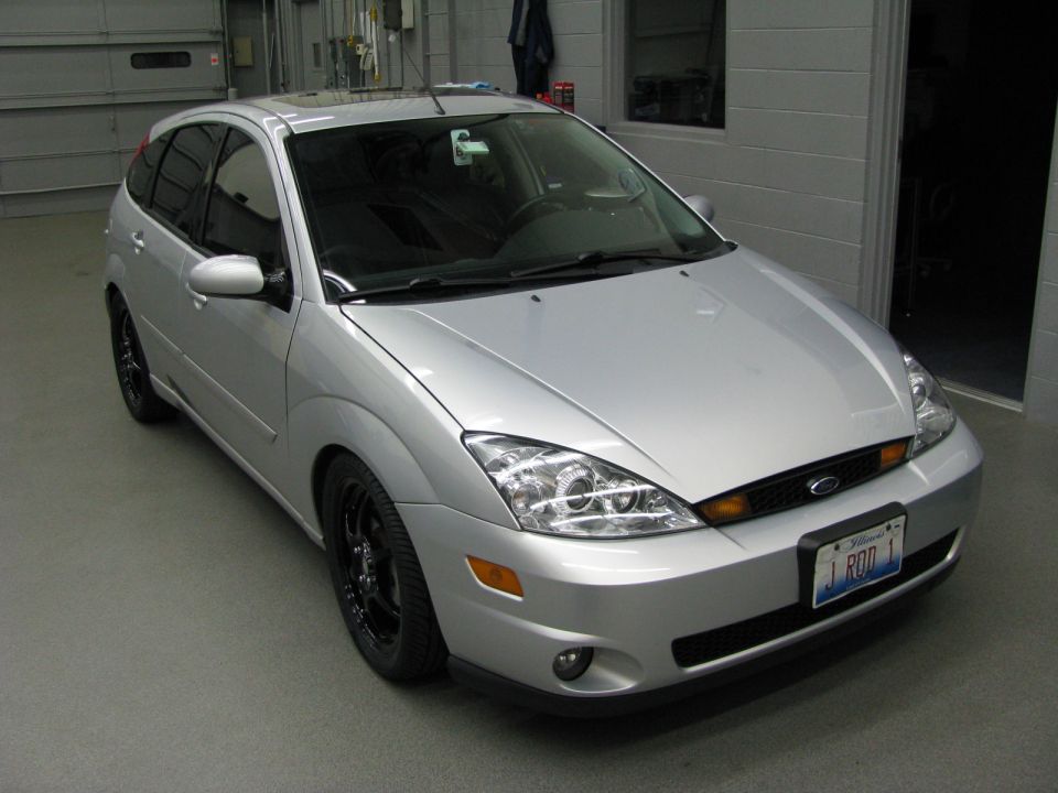 Silver 2003 Ford Focus hatchback parked inside a garage