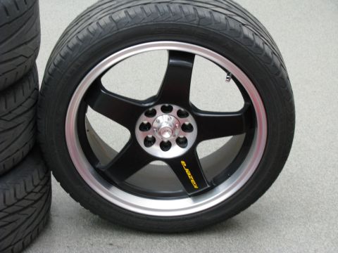 2003 Ford Focus - Close-up of a black Kazera wheel and tire, with other tires stacked nearby.