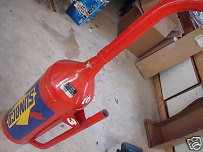 1993 Ford C-350 (Centurion Conversions) - A red and blue Sunoco branded object is on the floor with boxes in the background.